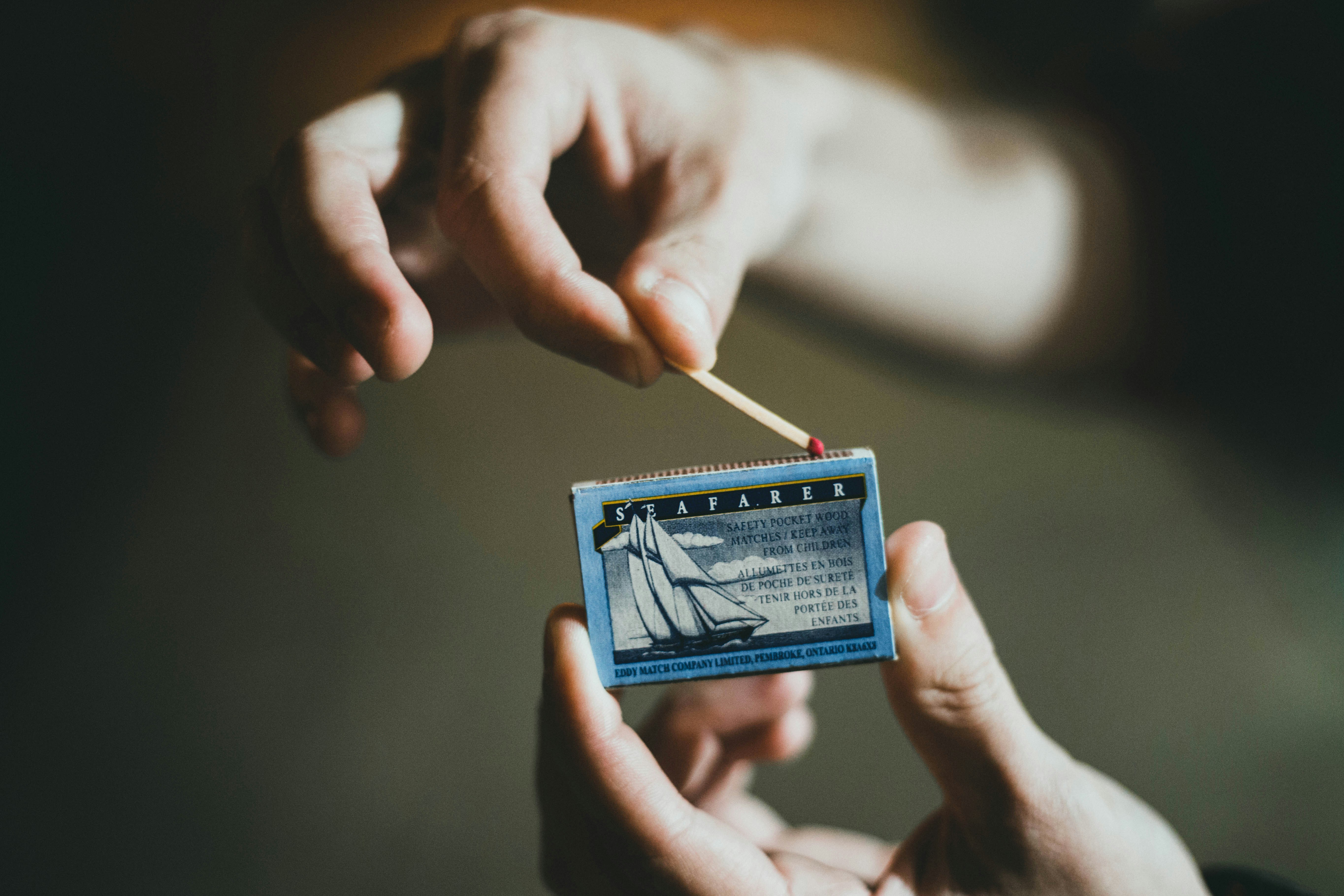 person holding blue and white card